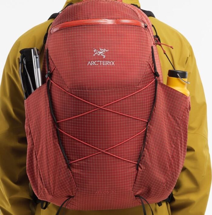 Front cord and large side pockets, top zippered pocket also visible.